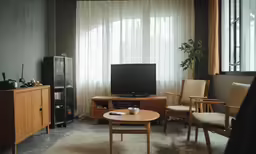 living area with furniture, television and large windows