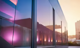 windows with a building with city lights behind them