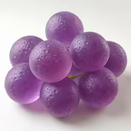 a bunch of grapes with water drops sitting on top