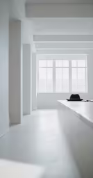 a long white counter with a hat on it