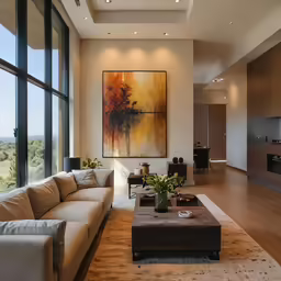 the living room is filled with furniture and a large painting