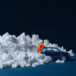 there is a toy man working on a car