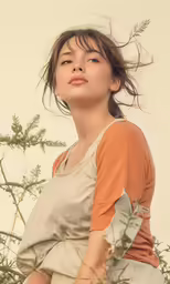 a beautiful young woman sitting on a branch