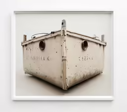 a framed photo of an old boat sits in the center