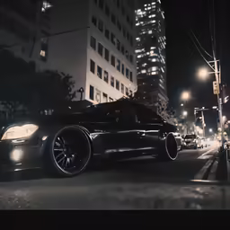 a black sports car on a street at night