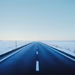 the road has white lines on the side and no traffic