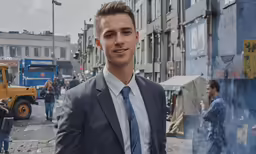 man in gray suit standing on street with crowd around him