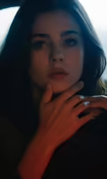 a beautiful young woman holding her hand to her mouth