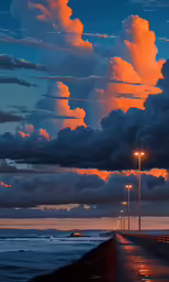 an empty beach lined with lit poles and tall pillars