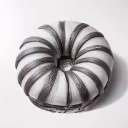 a round muffin with stripes sits on the white floor