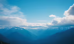 some mountains are seen through the clouds