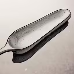 a very cute looking spoon that is in some water