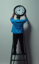 the person is balancing a clock on his head