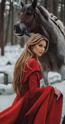 woman dressed in red with her horse in snowy forest