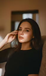 a woman sitting on a couch posing for a photo