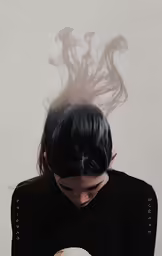 an image of woman with a ghost like look on her face