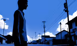 a man standing in the street and the sky is blue