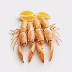 four carrots are arranged next to a lemon