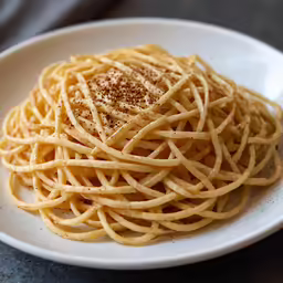 the plate has pasta with spices in it