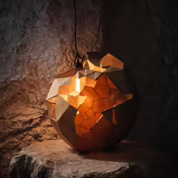 a table lamp is set on top of some rocks