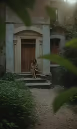 a person sits on the steps of an old style building