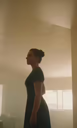 woman standing alone in the sun looking towards the horizon