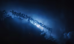 letters are spray painted over a dark hill