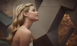 an attractive blond woman wearing a white dress