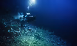 a light shines in the dark as it shines from underwater