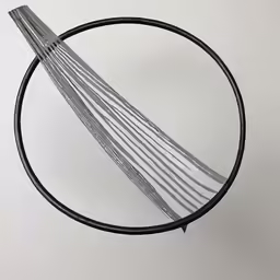 a round mirror with different lines hanging on it