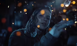 a woman holds a glass in her hands and looks at it