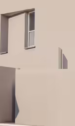 a window and a concrete wall with a white gate