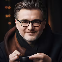 a man in black holding up a camera