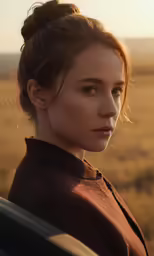 a girl posing for an advertisement in front of a sunset