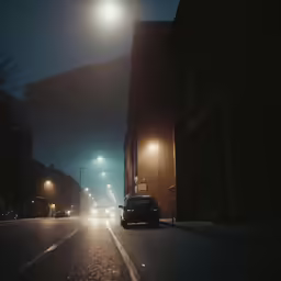 a car drives down a city street at night