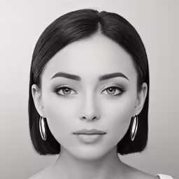 a woman with long black hair and earrings