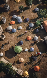 an overhead shot of umbrellas, people and small trees