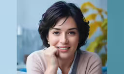 there is a woman with very short hair smiling