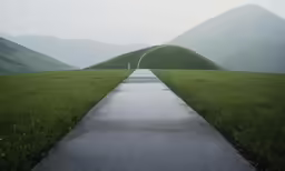 the pathway stretches along an empty road in the mountains