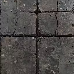 close up of several square rocks near water