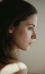 a woman is looking down and to the left