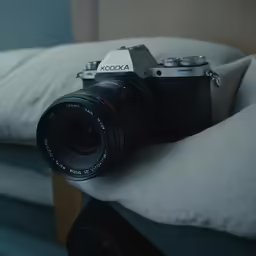 a small camera sitting on top of a pillow