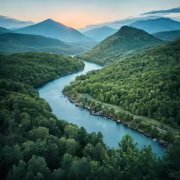 the mountains surrounding a river surrounded by forest