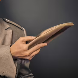 a man in a grey jacket holding something brown
