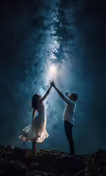 two people are in the middle of holding hands as they reach for a star