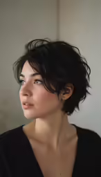 a woman with wavy hair and a black shirt