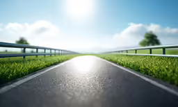 an empty asphalt road is pictured on a sunny day