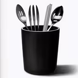 spoons and forks sit in a black cup