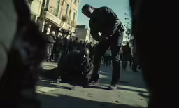 a man looking over the ground on top of another person