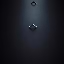 two pairs of black rings sit on a black surface